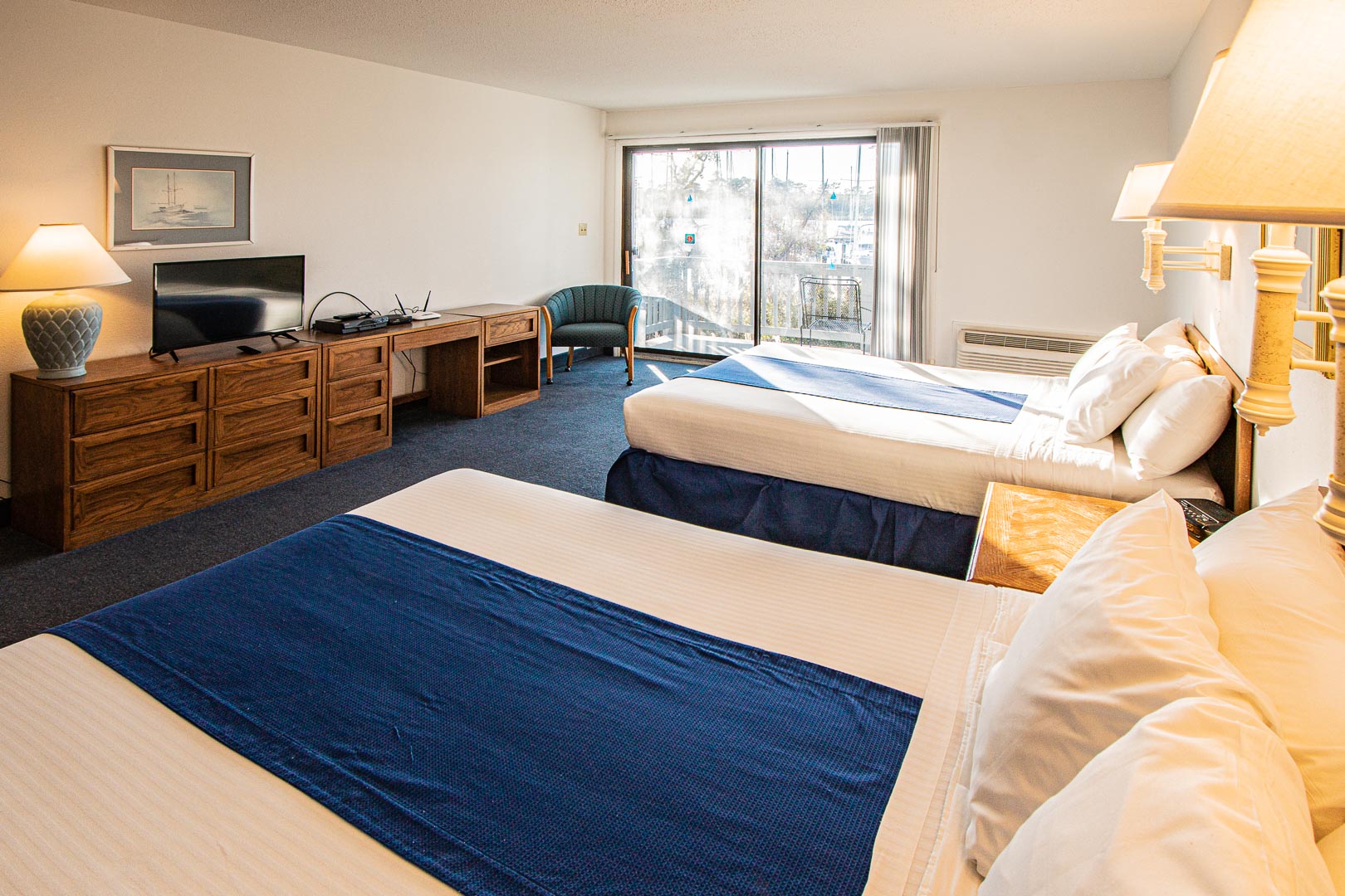 A spacious bedroom with double beds at VRI's Harbourside II in New Bern, North Carolina.
